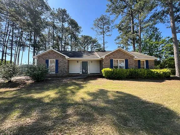 a house with swimming pool in front of it