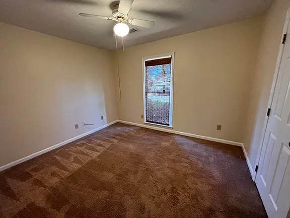 a view of empty room with ceiling fan