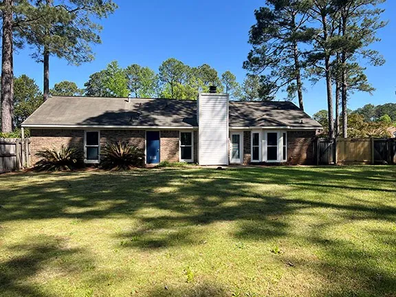 a front view of a house with a garden