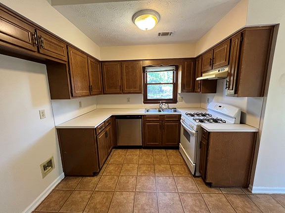 1 Handshaker Lane Columbus, GA 31909 - Photo 6 of 17 a kitchen with stainless steel appliances granite countertop a stove a sink dishwasher and a refrigerator