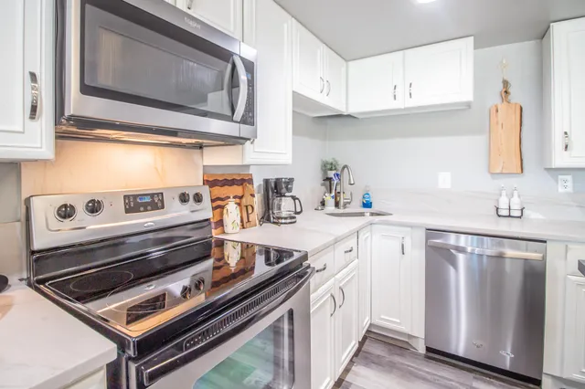 a kitchen with a stove microwave and sink
