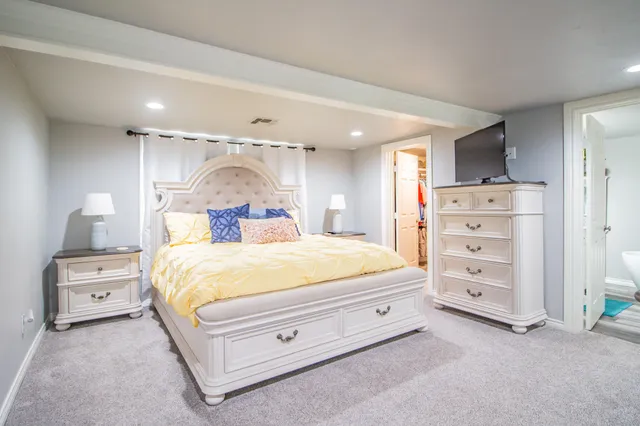 a bedroom with a bed and a dresser