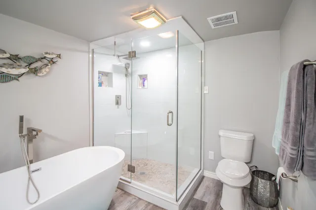 a bathroom with a toilet and a shower