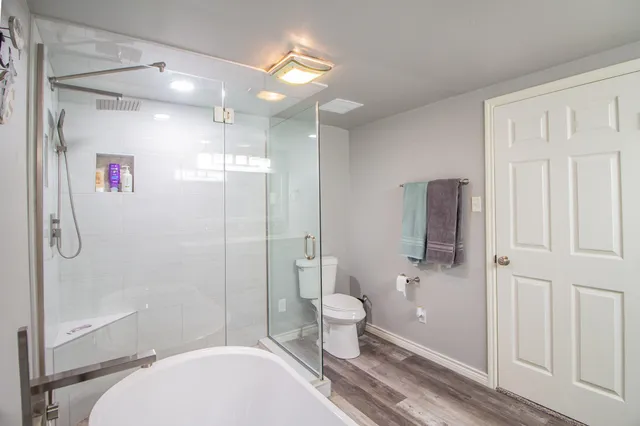 a bathroom with a toilet a sink and shower