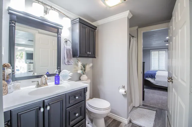 a bathroom with a toilet sink and mirror