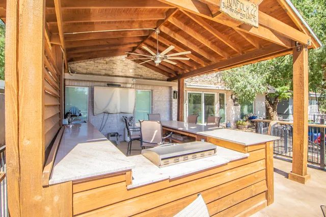 a view of a backyard with swimming pool and furniture