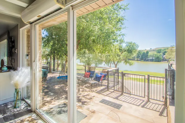 a view of a balcony with lake view and a floor to ceiling window
