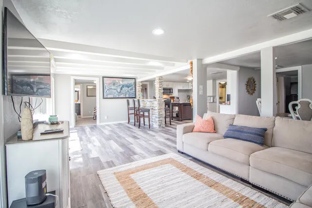 a living room with furniture and a wooden floor