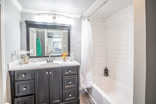 a bathroom with a tub sink and mirror