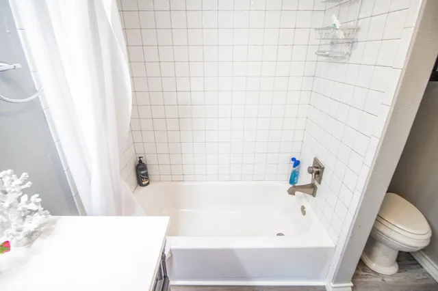 a bathroom with a bathtub and toilet