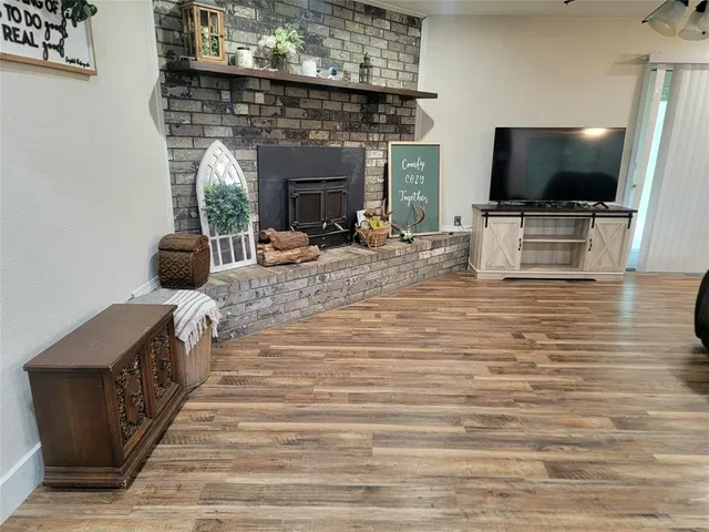 a living room with fireplace furniture and a flat screen tv