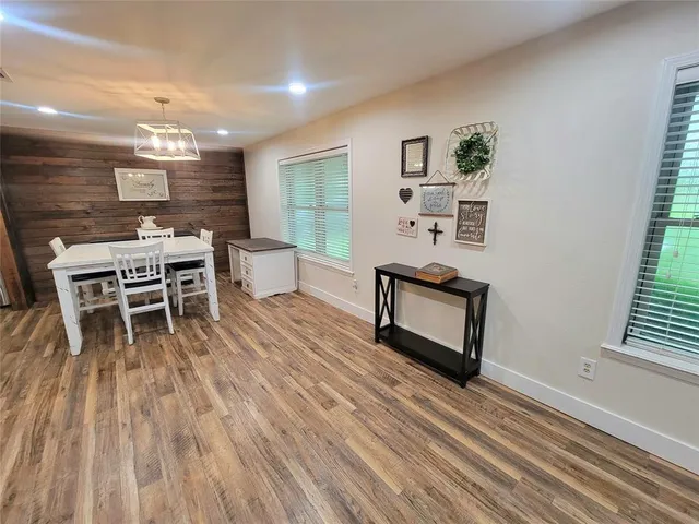 a dining room with furniture a rug and wooden floor