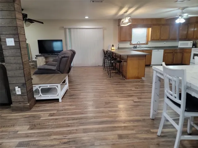 a kitchen with stainless steel appliances kitchen island granite countertop a stove a sink and a microwave