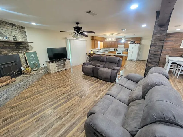 a living room with furniture a flat screen tv and a fireplace