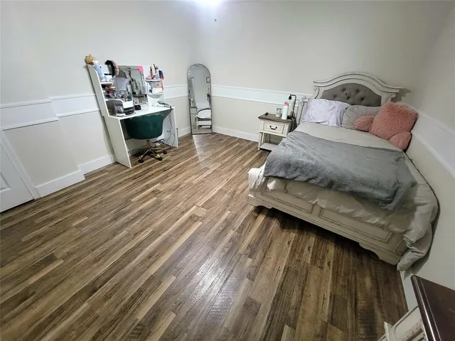 a bedroom with a bed and a tv