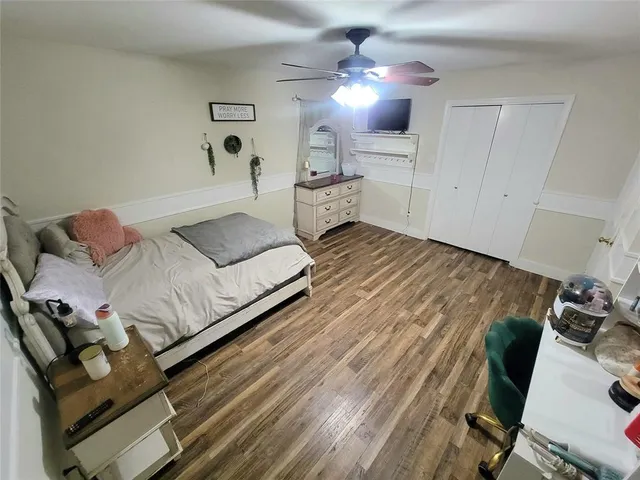 a spacious bedroom with a bed and furniture