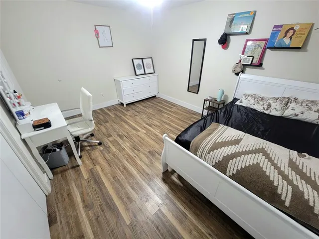a living room with a bed furniture and a flat screen tv