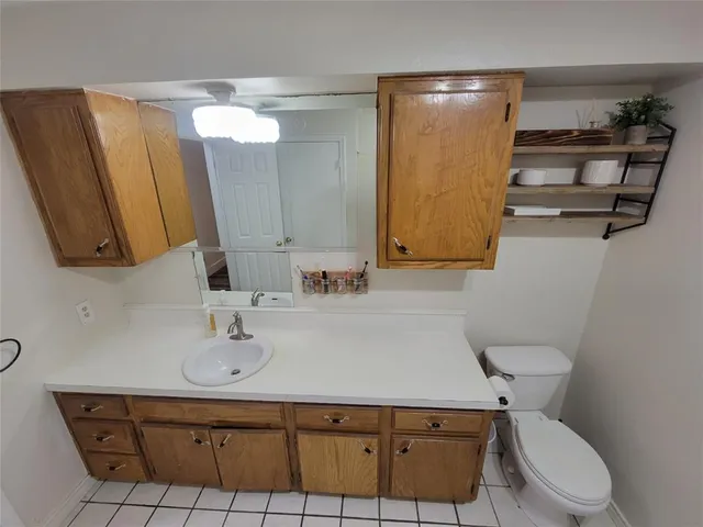 a bathroom with a sink a toilet and mirror