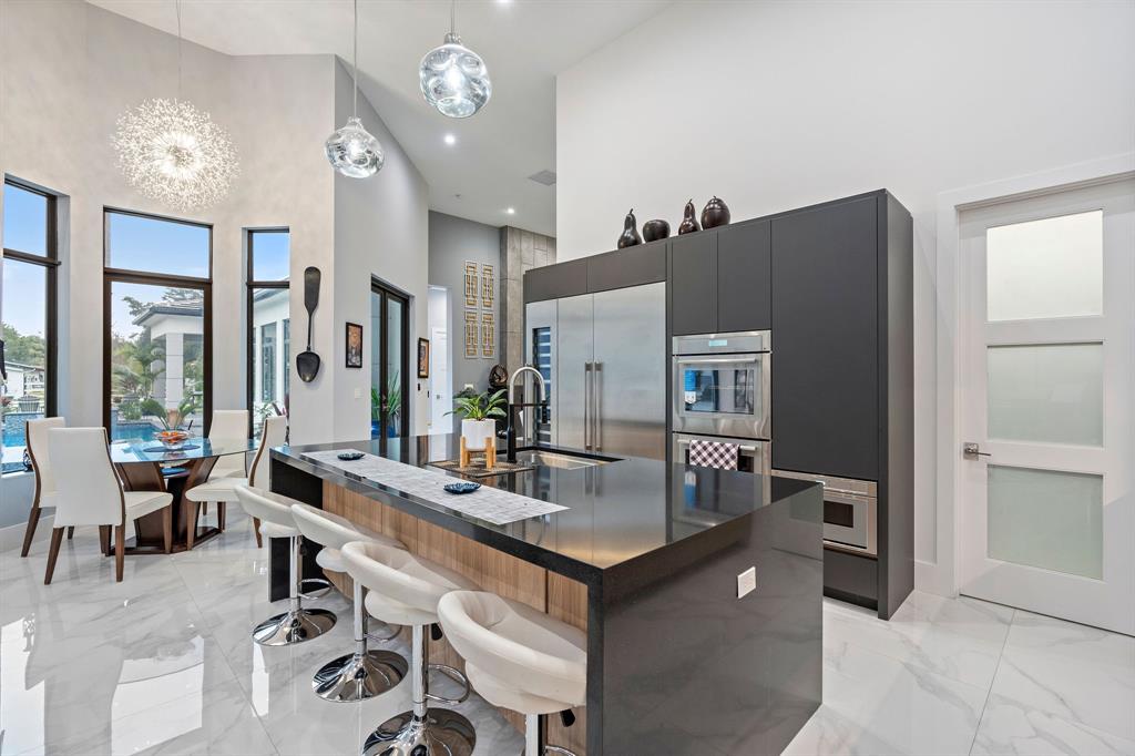 13500 Stirling Road Southwest Ranches, FL 33330 - Photo 12 of 72 a living room with furniture a chandelier and a dining table