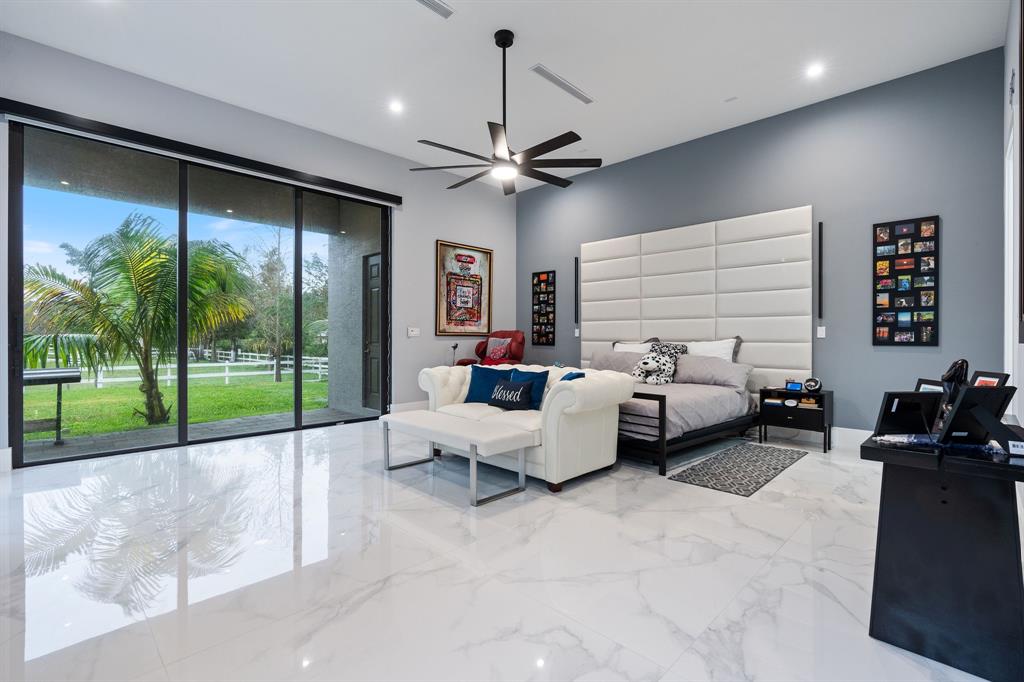13500 Stirling Road Southwest Ranches, FL 33330 - Photo 31 of 72 a living room with furniture and a floor to ceiling window