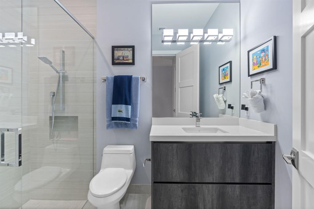 13500 Stirling Road Southwest Ranches, FL 33330 - Photo 44 of 72 a bathroom with a toilet a sink a mirror and a shower