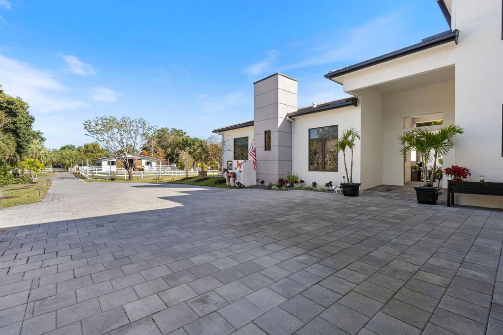 13500 Stirling Road Southwest Ranches, FL 33330 - Photo 65 of 72 a view of a house with a road
