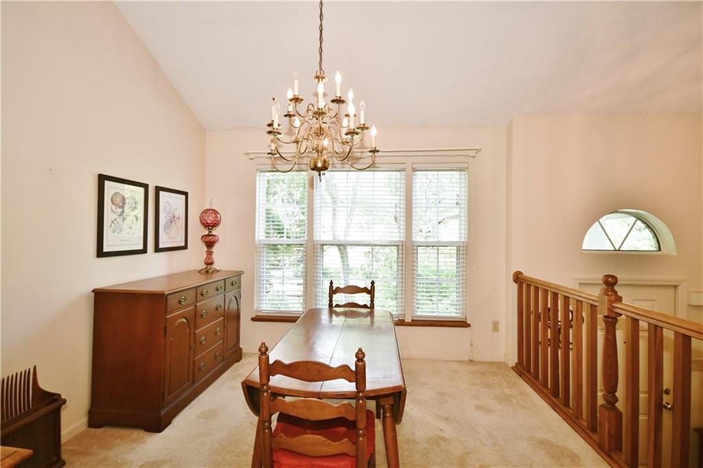The dining room is sunlit with its large triple window.