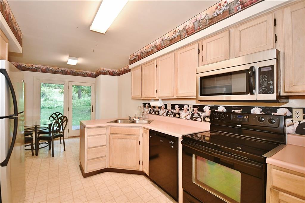 2437 Lytle Road Bethel Park, PA 15102 - Photo 8 of 25 Tons of cabinets and counter space and newer appliances for the work area. The breakfast area has a nice view of the outdoors.