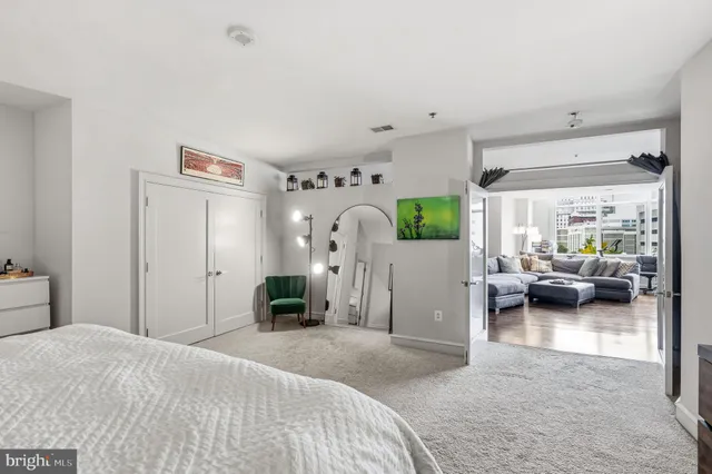 a bedroom with furniture and a large window