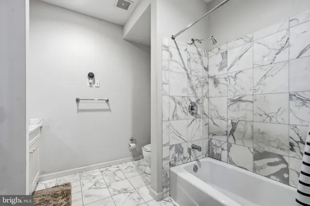 a bathroom with a bathtub and shower