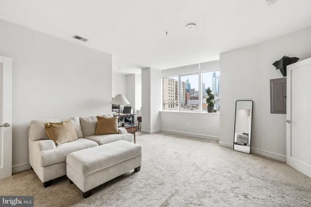 a living room with furniture and a window