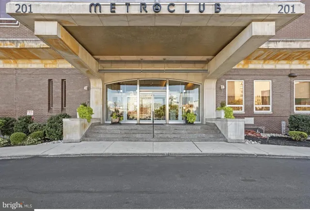 a view of a house with a cars park side of a road