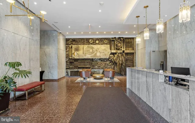 a living room with furniture a flat screen tv and a large window