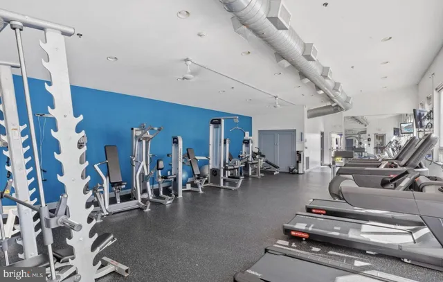 a gym room with lots of gym equipment