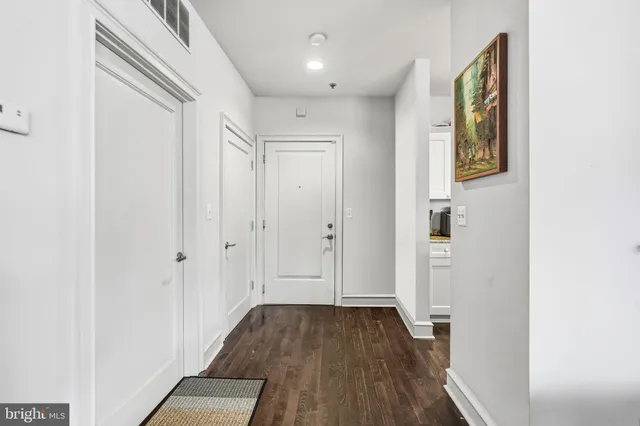a view of a hallway with wooden floor