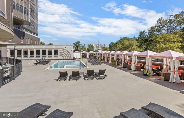 a view of a swimming pool with outdoor seating