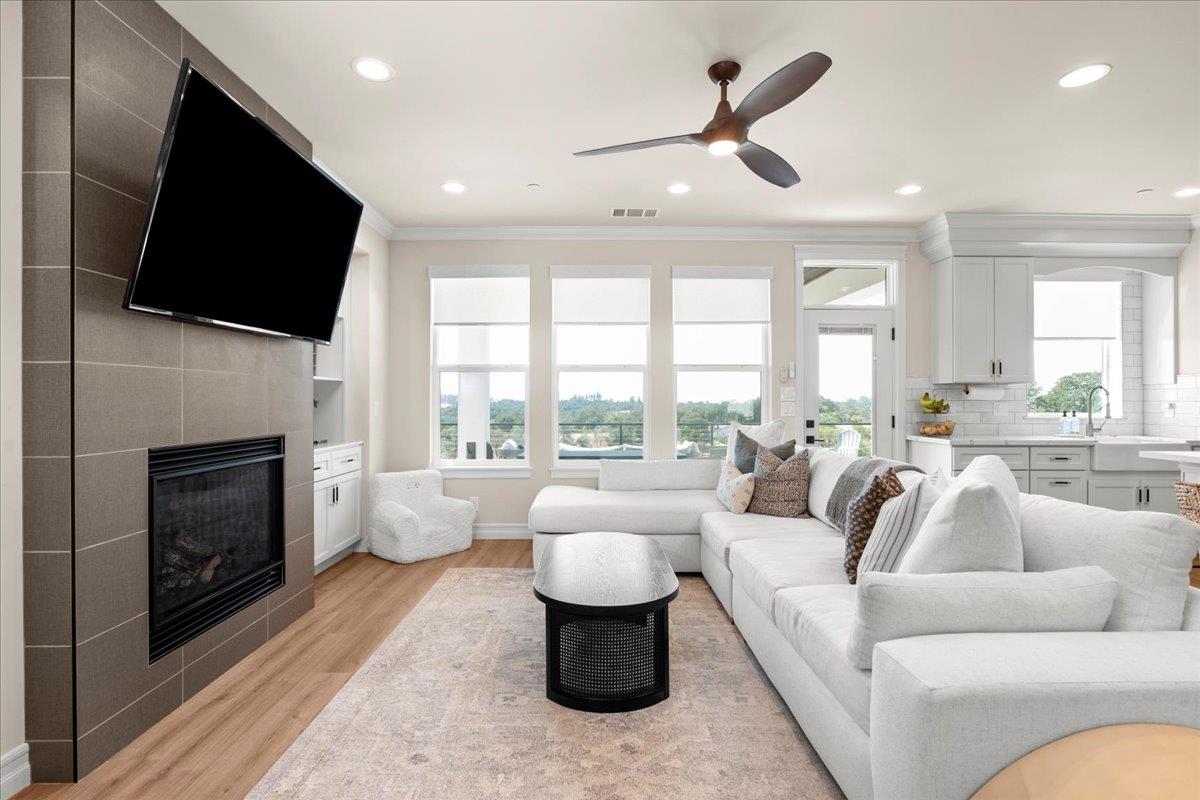 3775 Bell Road Auburn, CA 95603 - Photo 11 of 45 a living room with furniture a fireplace and a flat screen tv