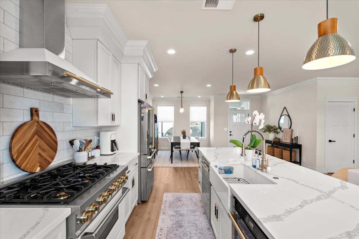 3775 Bell Road Auburn, CA 95603 - Photo 14 of 45 a kitchen with kitchen island granite countertop lots of counter top space a sink a stove and a wooden floors