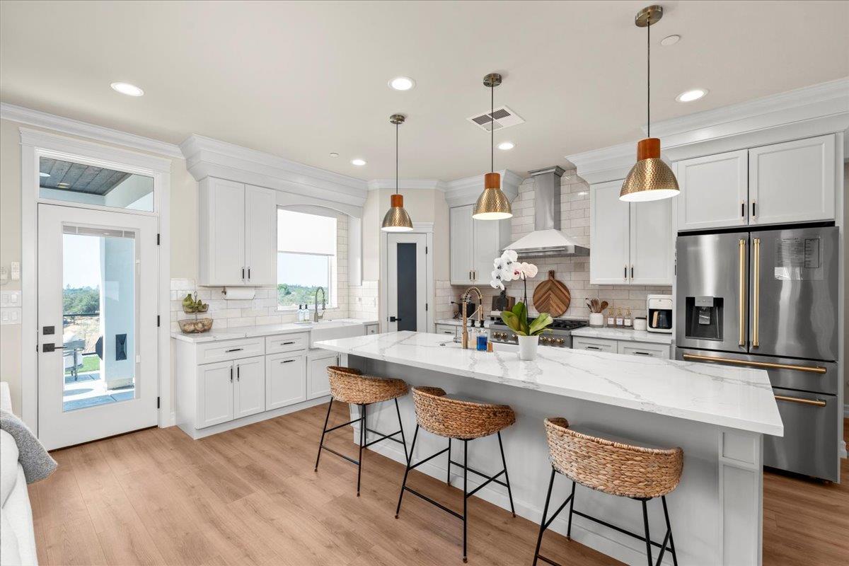 3775 Bell Road Auburn, CA 95603 - Photo 18 of 45 a kitchen with stainless steel appliances granite countertop a refrigerator a sink dishwasher a stove and white cabinets with wooden floor