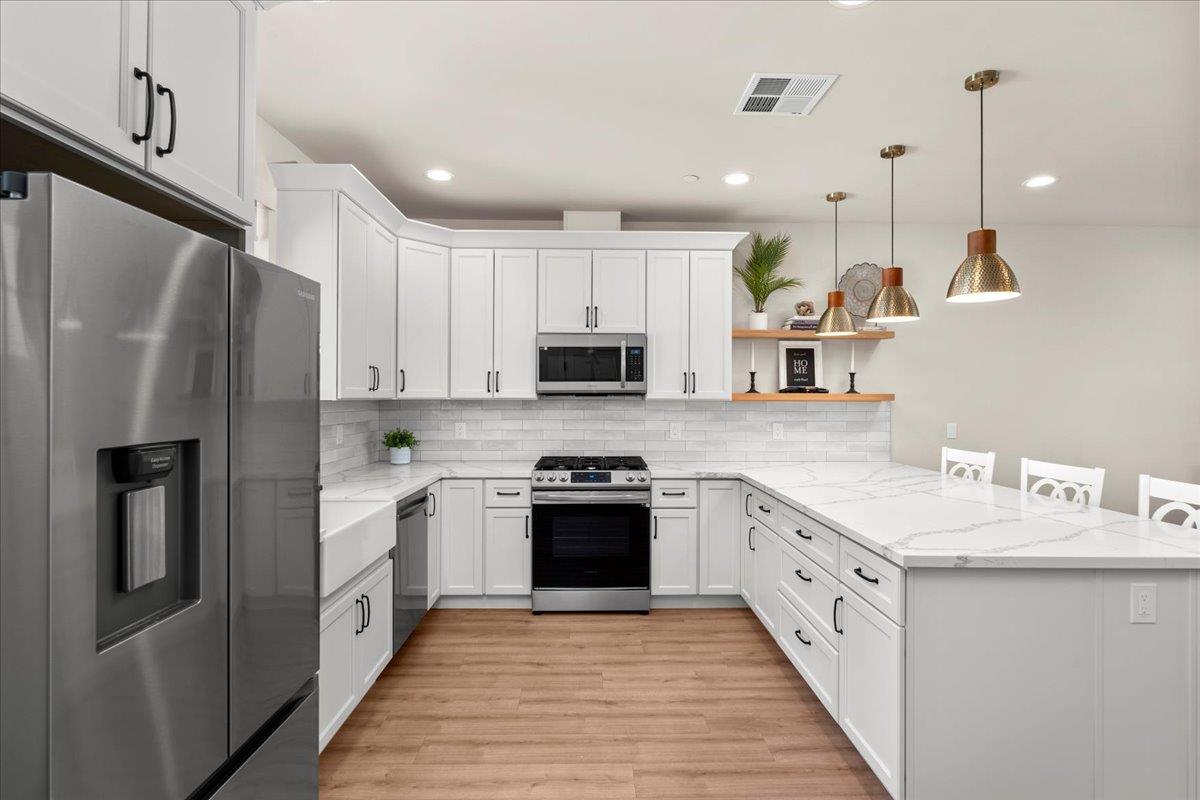 3775 Bell Road Auburn, CA 95603 - Photo 37 of 45 a kitchen with stainless steel appliances granite countertop a refrigerator a stove a sink and a microwave