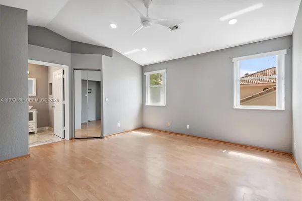 an empty room with windows and closet