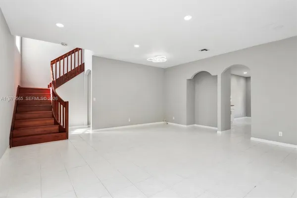 wooden floor in an empty room with a staircase