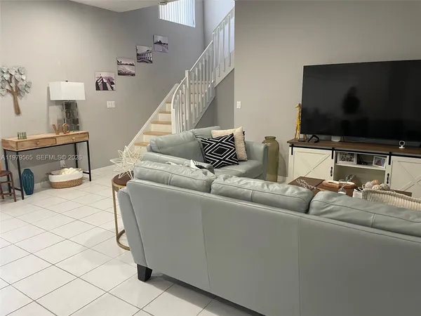 a living room with furniture and a flat screen tv