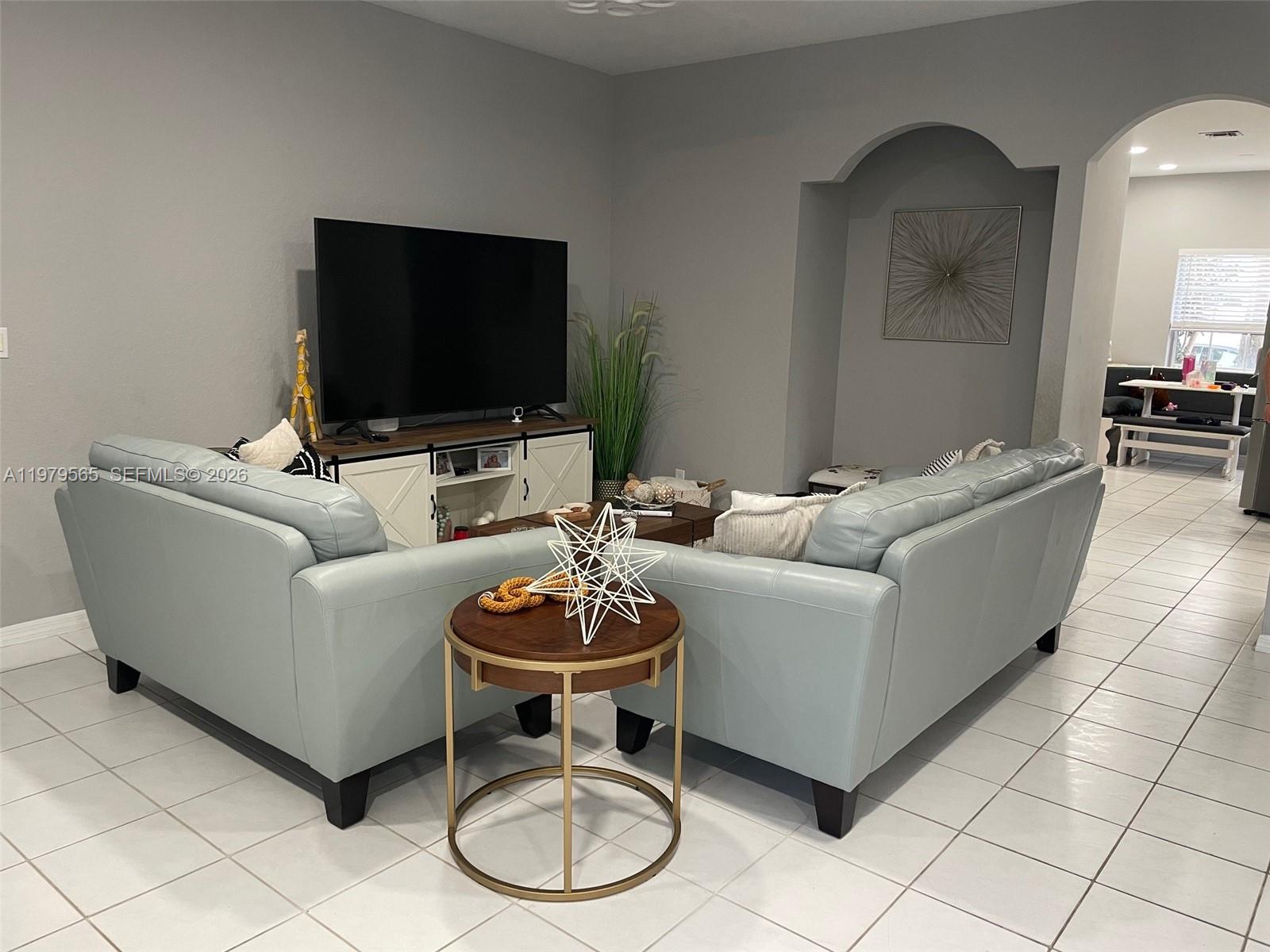 7234 Panache Way Boca Raton, FL 33433 - Photo 7 of 23 a living room with furniture and a flat screen tv