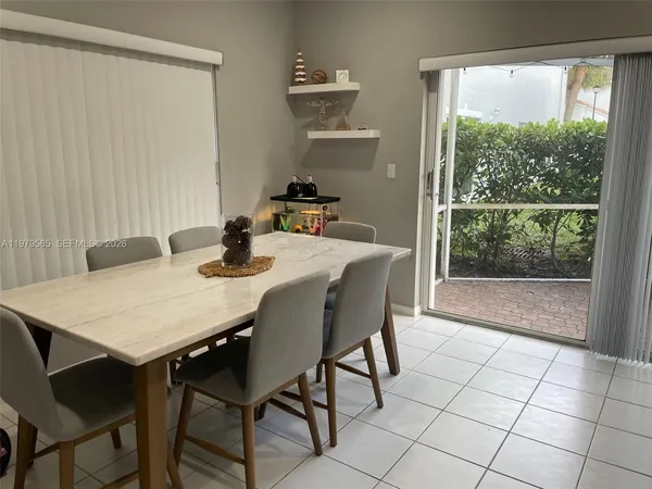 a dining room with furniture and window