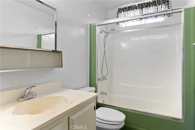 an empty room with closet and windows