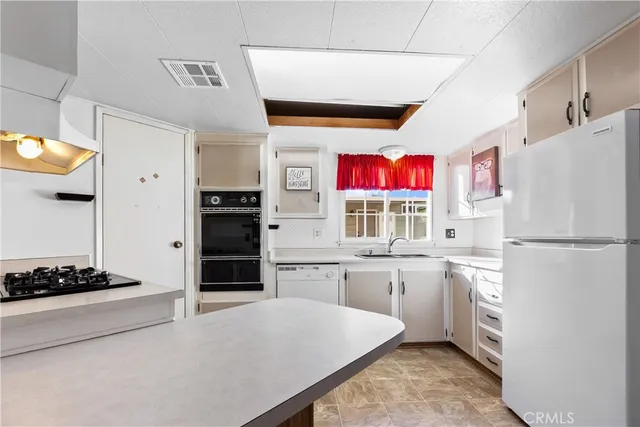 a view of a kitchen with kitchen sink