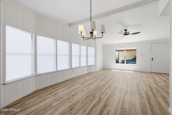 a view of a kitchen with wooden floor and a chandelier