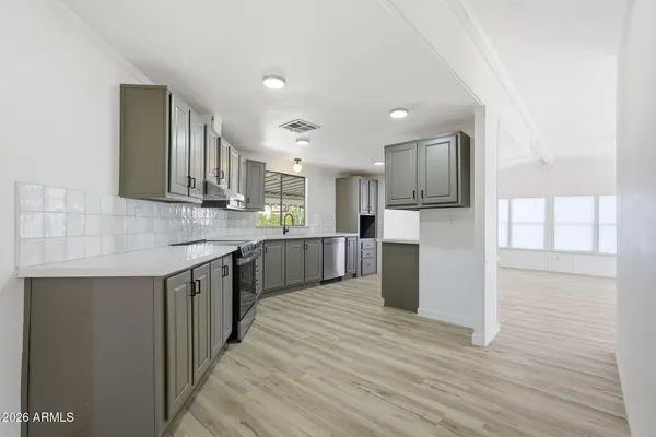 a kitchen with a sink cabinets and wooden floor