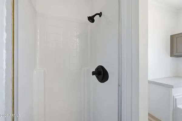 a bathroom with a double vanity sink a mirror and a bathtub